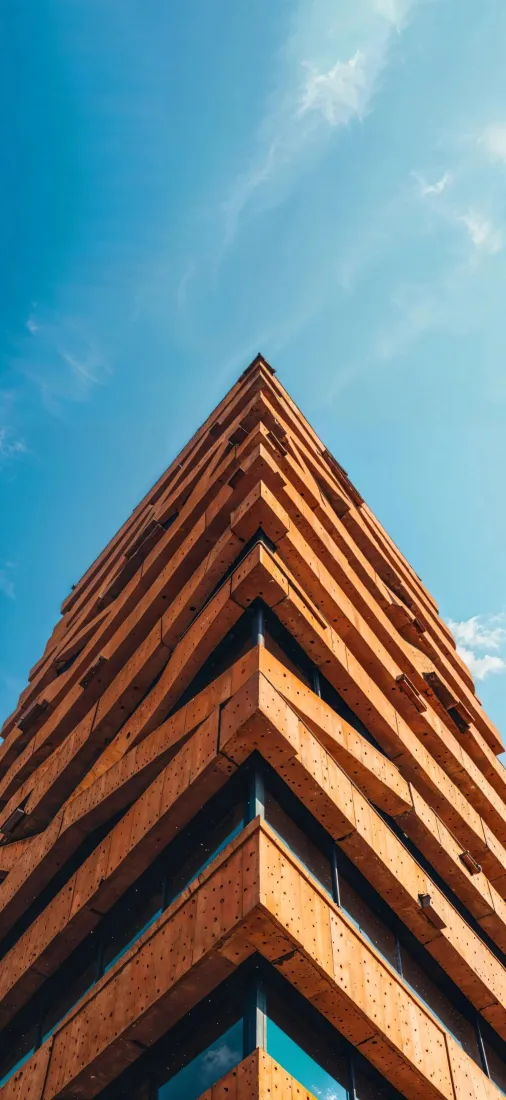 橙红色高楼手机壁纸｜蓝天背景图片 - 现代建筑几何棱角仰拍「哲风壁纸」